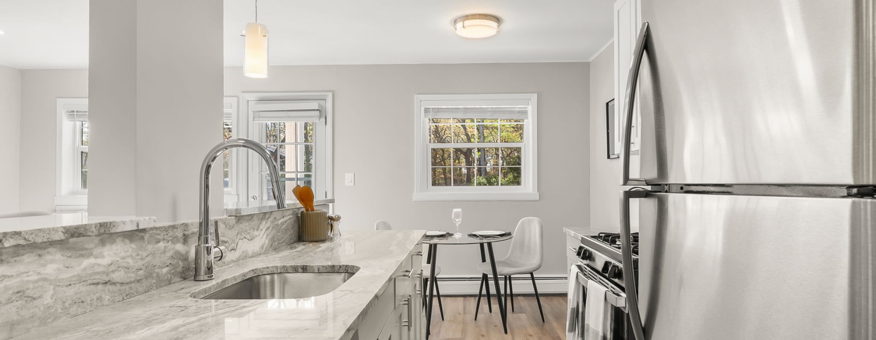 kitchen with stainless steel appliances and dining room in view