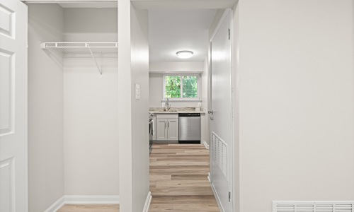 closet with hallway with wood flooring