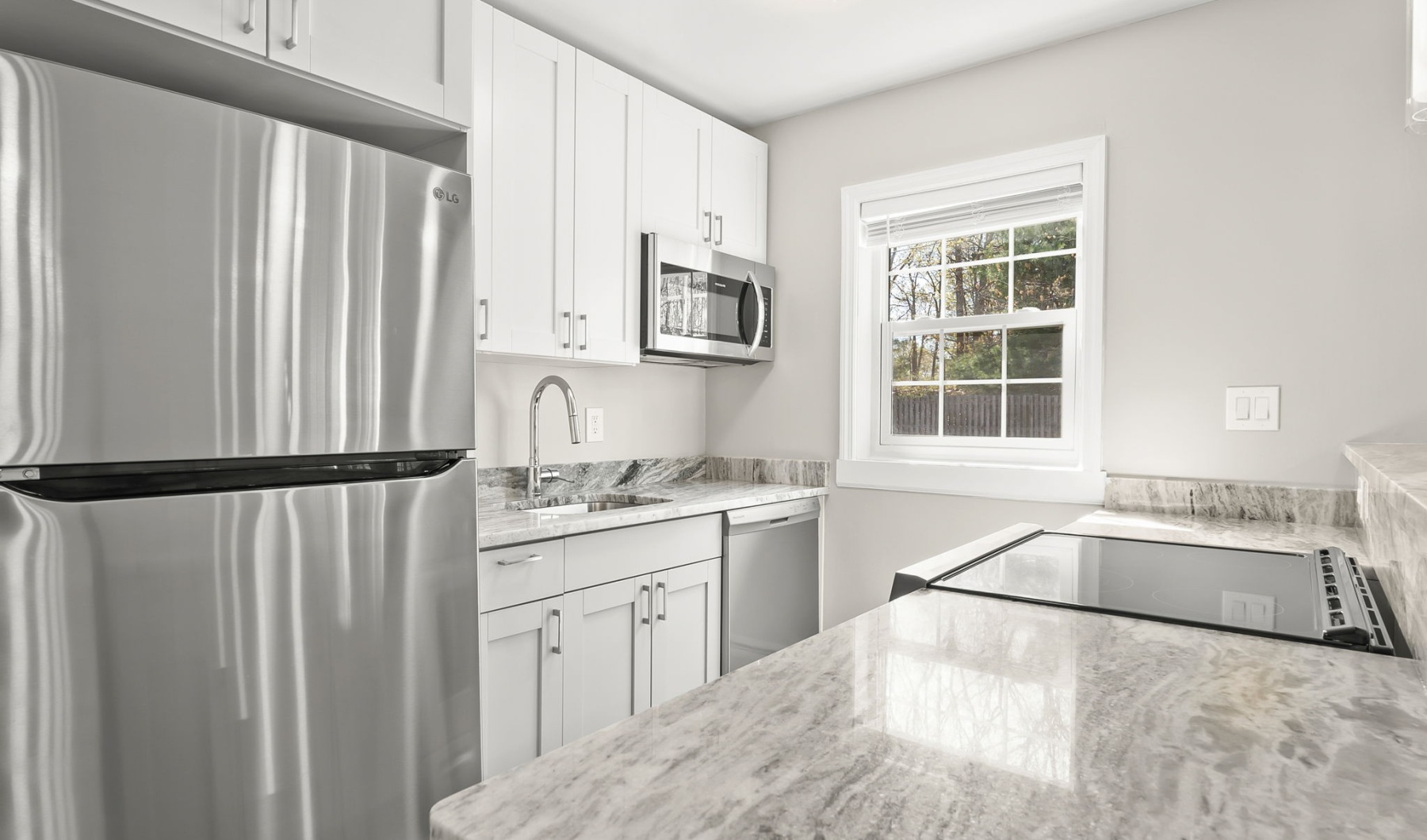 kitchen with stainless steel appliances and white cupboards